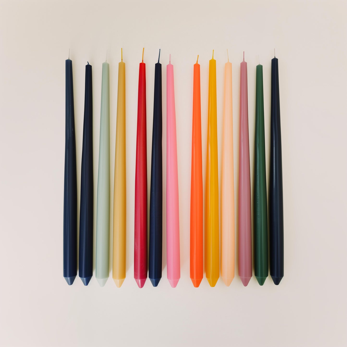 Set of COSYPLACE CANDLES in various sizes, featuring warm-colored wax and flickering flames on a wooden surface.